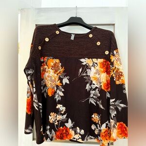 Long sleeve floral and color block shirt. Button detail on shoulder